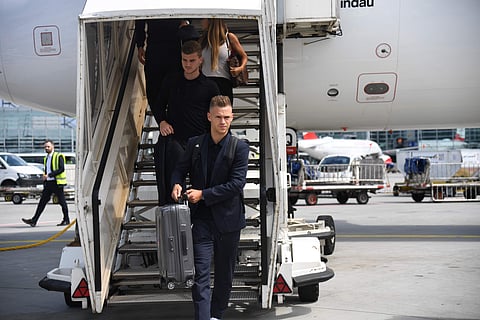 Joshua Kimmich, front, and Timo Werner leave a plane in Frankfurt, Germany, Thursday, June 28, 2018, one day after the German team was eliminated from the soccer World Cup in Russia. | AP