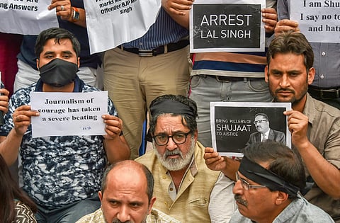 Journalists hold placards during a silent protest march against the killing of Rising Kashmir newspaper editor-in-chief Shujaat Bukhari in Srinagar. (PTI)