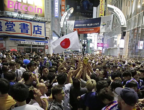 Japanese fans celebrate at Shibuya crossing in Tokyo, as Japan advanced to the next stage of the 2018 FIFA World Cup. (Photo | AP)