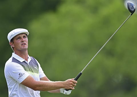 Bryson DeChambeau follows his tee shot on the 18th hole during the third round of the Memorial golf tournament. | AP