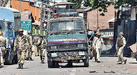 Security personnel patrol a Srinagar road littered with stones thrown during clashes on June 2, 2018.| PTI