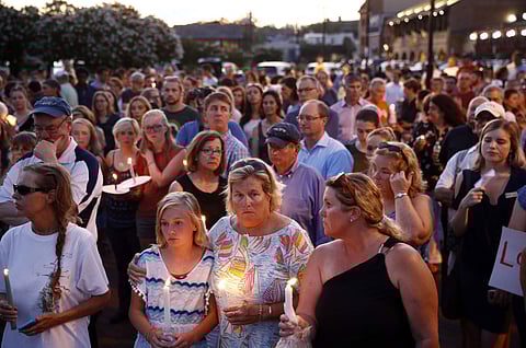 Mourners stand in silence during a vigil in response to a shooting at the Capital Gazette newsroom in Annapolis, Maryland. (Photo | AP)