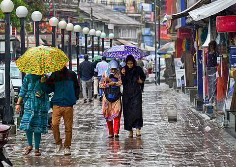 Pedestrians walk with umbrellas during heavy rains in Srinagar on Friday June 29 2018. Heavy rains lashed several parts of the Valley including the state's summer capital today even as the authorities advised people residing near streams in south Kashmir 