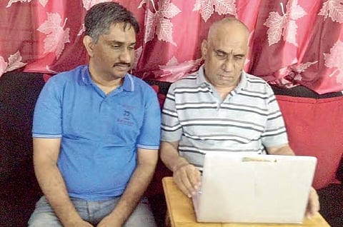 (left) Fani Kiran and V Sambasiva Rao  who developed the Telugu Bhagavatham app, the complete works of Bammera Pothana | express