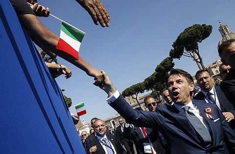 Italian Premier Giuseppe Conte is greeted by citizens on the occasion of the celebrations for Italy's Republic Day, in Rome Saturday, June 2, 2018. | AP