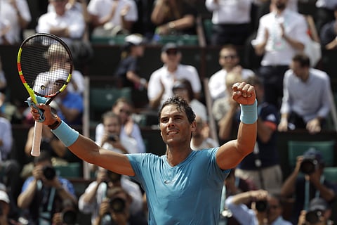 Spain's Rafael Nadal raises in arms in victory as after defeating Germany's Maximilian Marterer during their fourth match of the French Open tennis tournament. | AP