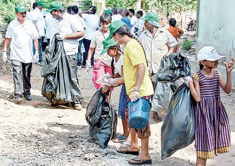 Local residents remove plastic littered all over a canal bund as part of the ‘Beat Plastic Pollution’ campaign