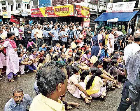 Synthite employees staging a sit-in after they were stopped from entering the factory on Monday | Express