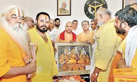 Uttar Pradesh Chief Minister Yogi Adityanath poses for a photo with a delegation of sadhus and saints in Lucknow on Thursday | pti