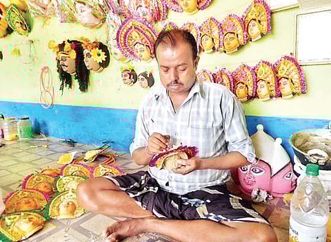 Chhau mask-maker Raju Sutradhar at work in his shop in Chorida village in West Bengal’s Purulia district | AISHIK CHANDA