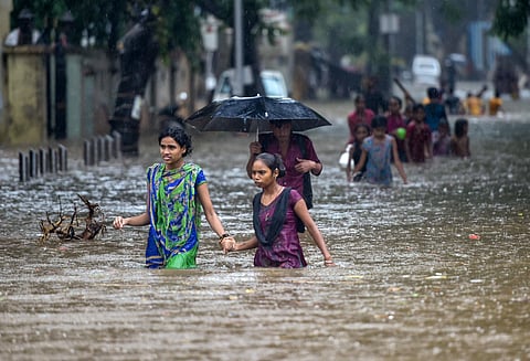 Mumbai received heavy rainfall today following the onset of the southwest monsoon, leading to a slight delay in the running of suburban trains. (Photo | PTI)