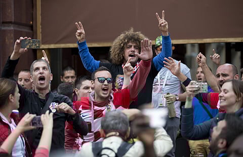 Croatia soccer fans cheer in Nikolskaya street near the Kremlin during the 2018 soccer World Cup in Moscow, Russia, Tuesday, July 10, 2018. | AP