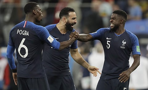 France's Samuel Umtiti, right celebrates with teammates France's Adil Rami, centre and France's Paul Pogba after defeating Belgium in their semifinal match between France and Belgium at the 2018 soccer World Cup in the St. Petersburg Stadium in, St. Petersburg, Russia, Tuesday, July 10, 2018. | AP