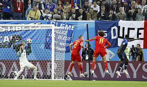 France's Samuel Umtiti, right, scores his side's opening goal during the semifinal match between France and Belgium at the 2018 soccer World Cup in the St. Petersburg Stadium, in St. Petersburg, Russia, Tuesday, July 10, 2018. | AP