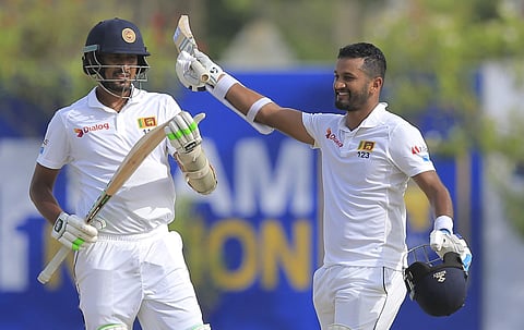 Sri Lanka's Dimuth Karunaratne, right, celebrates scoring a century as Suranga Lakmal watches during the first day's play of their first test cricket match with South Africa in Galle, Sri Lanka. (Photo | AP)