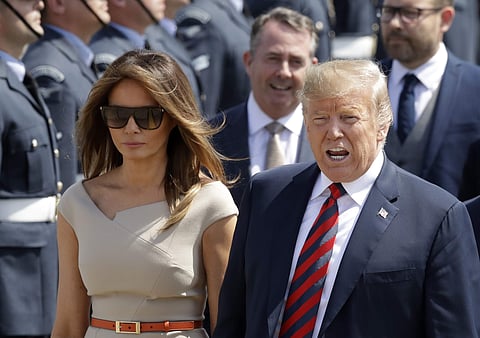 U.S. President Donald Trump and First Lady Melania Trump are greeted after disembarking from Air Force One as they arrive at London Stansted Airport | AP