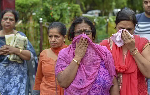 Relatives mourn during cremation of the 11 members of a family who were found hanging at in their house in Burari at Nigambodh Ghat in New Delhi on Monday July 2 2018. (Photo| PTI)