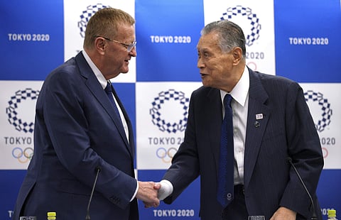 John Coates, left, chairman of the IOC Coordination Commission for the 2020 Tokyo Olympics and Paralympics, and Tokyo Olympic organizing committee President Yoshiro Mori, right, shake hands after the IOC and Tokyo 2020 joint press conference in Tokyo. (Ph
