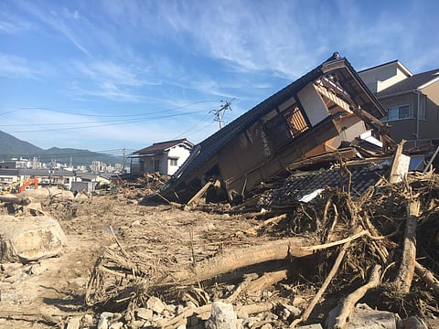 Damaged houses and a mud-covered road are seen in the aftermath of heavy rains in Hiroshima, southwestern Japan ( Photo | AP)