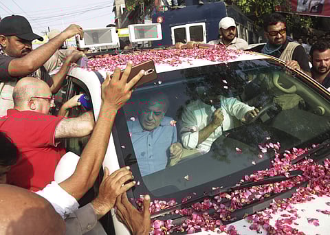 Shahbaz Sharif, sits in car on left, brother of Pakistani former prime minister Nawaz Sharif leaves for airport in Lahore, Pakistan (Photo | AP)