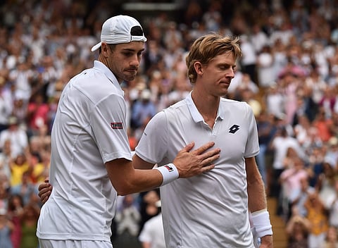 Kevin Anderson of South Africa, right, meets John Isner of the US on the court after defeating him in their men's singles semifinal match at the Wimbledon Tennis Championships, in London, Friday July 13, 2018.  | AP
