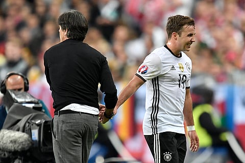 Germany coach Joachim Loew, left, shakes hands with Germany's Mario Goetze. (File photo | AP)