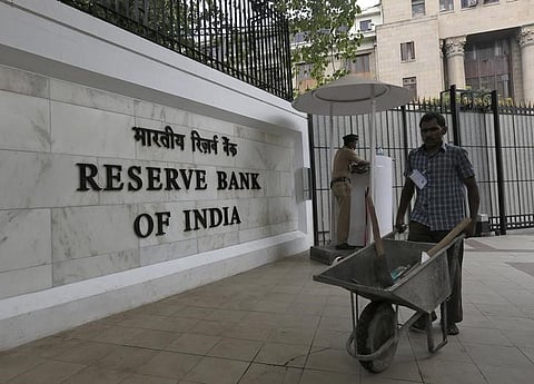 A worker pushes a wheelbarrow inside the Reserve Bank of India (RBI) head office in Mumbai, India, April 5, 2016. | Reuters