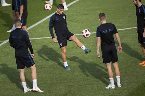 Croatia's Andrej Kramaric plays the ball with teammates during Croatia's official training session in the Luzhniki sport complex on the eve of the final match between Croatia and France at 2018 soccer World Cup in Moscow, Russia, Saturday, July 14, 2018. 
