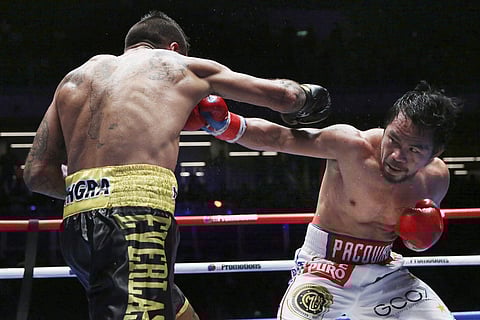 Manny Pacquiao of the Philippines, right, fights Lucas Matthysse of Argentina during their WBA World welterweight title bout in Kuala Lumpur, Malaysia. | AP