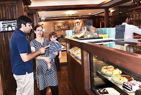 Saqib Mir with wife Melanie and younger son at their bakery Le Délice’, in Srinagar. (Photo | EPS)