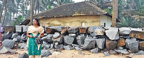 Nileshwaram councillor Beena T P in front of her house at Thaikadappuram. She abondoned the house after waves breached the sea wall and started lashing the wall of her house