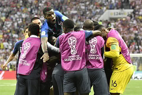 Paul Pogba, top, jumps as his teammates celebrate after Kylian Mbappe scored his side's fourth goal during the final match between France and Croatia at the 2018 soccer World Cup in the Luzhniki Stadium in Moscow. | AP