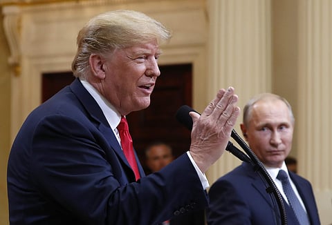 U.S. President Donald Trump speaks with Russian President Vladimir Putin during a press conference after their meeting at the Presidential Palace in Helsinki, Finland. (Photo | AP)