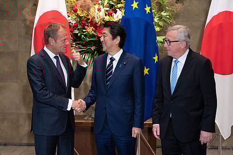 Japanese Prime Minister Shinzo Abe, center, shakes hands with European Council President Donald Tusk next to European Commission President Jean-Claude Junker, right, before a meeting at Abe's official residence in Tokyo (Photo | AP)