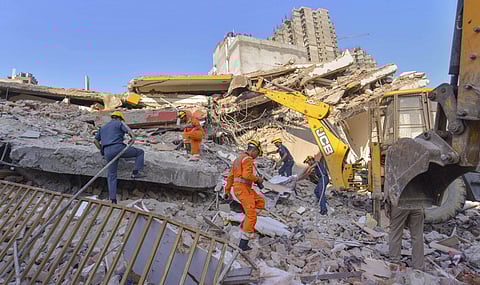 Rescue workers search for survivors under the debris of a collapsed building at Shahberi village in Greater Noida West on Wednesday July 18 2018. | PTI