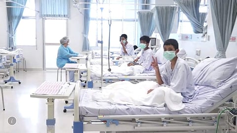 Three of the 12 boys are seen recovering in their hospital beds after being rescued along with their coach from a flooded cave in Mae Sai, Chiang Rai province. ( File | AP)