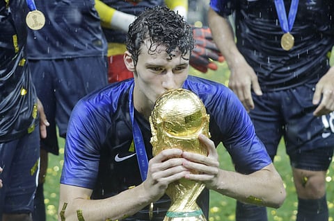 Benjamin Pavard kisses the trophy at the end during the final match between France and Croatia at the 2018 soccer World Cup in the Luzhniki Stadium in Moscow. | AP