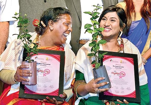 Social activist Akkai Padmashali shares a light moment with singer Supriya Lohit after being felicitated at Gandhi Bhavan on Sunday | shriram b n