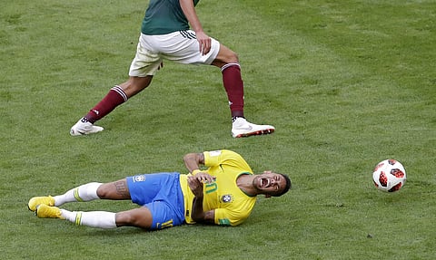 Brazil's Neymar, bottom, challenges for the ball with Mexico's Edson Alvarez during the round of 16 match at the 2018 soccer World Cup in the Samara Arena. | AP