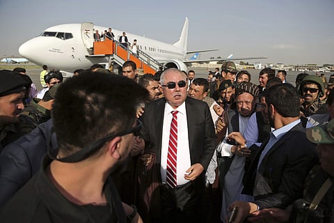 Afghan first vice president, a former Uzbek warlord, Gen. Abdul Rashid Dostum, center, and members of his entourage arrive at Kabul International Airport in Kabul. (Photo | AP)