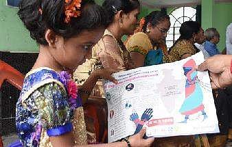 A kid showign the poster released during the Trafficking of Persons Bill meeting organised by HELP organisation in Vijayawada on Saturday | R V K Rao