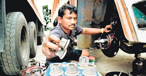 While truckers enter day two of the strike, a lorry driver makes the most of the day and services his vehicle at Yeshwantpur, Bengaluru, on Saturday | PANDARINATH B
