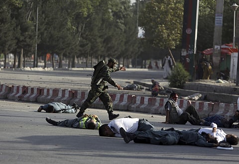 A suicide bomber carried out an attack near the Kabul airport Sunday, killing 14 people and narrowly missing Afghanistan's vice president, who was returning home after living in Turkey for over a year. (Photo | AP)