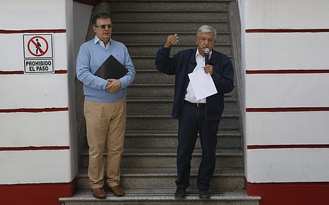 Mexico's President-elect Andres Manuel Lopez Obrador (R) and his future Foreign Minister Marcelo Ebrard speaks to the press outside his party's headquarters in Mexico City | AP