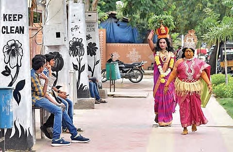 Artistes getting ready to perform at a cultural dance during a Bonalu festival procession at Hitech city, in Hyderabad on Sunday | R Satish Babu