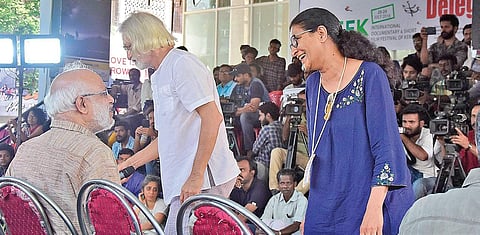 M A Baby talking to documentary filmmaker Kavitha Lankesh during the protest meeting at the IDSFFK venue in T’Puram on Sunday. Documentary filmmaker Anand Patwardhan is also seen. (Photo | EPS/B P Deepu)