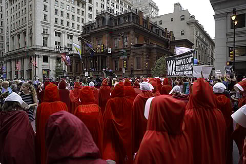 Dozens of demonstrators dressed as characters from the Margaret Atwood novel-turned-TV series 'The Handmaid's Tale' descended on downtown Philadelphia on Monday to protest US Vice President Mike Pence's visit in Philadelphia. (Photo | AP)