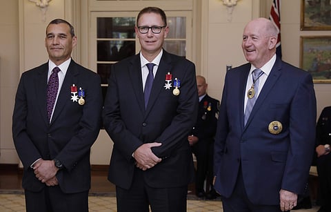 Australian members of the Thai cave rescue team, Craig Challen, left, and Dr. Richard Harris, center, stand with Australia's Governor-General Peter Cosgrove at a function at Government House in Canberra, Australia, Tuesday, July 24, 2018. | AP