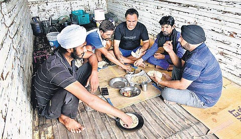 While strike continues, lorry workers have lunch prepared in their lorry. | Express Photo Service