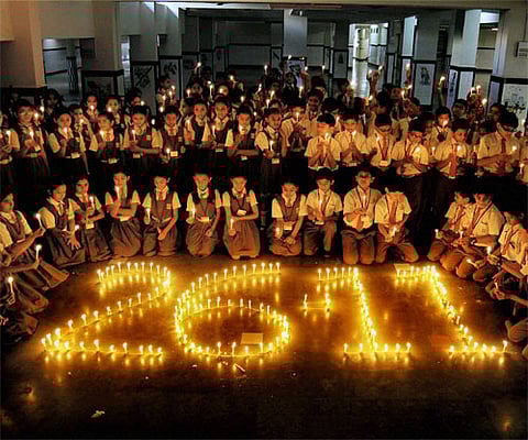 Children light candles in tribute to the victims of 26/11, in Surat. PTI